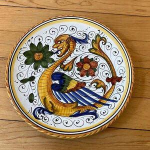 Italian Deruta pottery hand painted. 7.5” diameter with hanging holes.